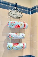 Floral towels on hanging towel rail 