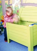 Small child playing in modern toy box 