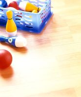 Toy bowling pins on wooden floor 