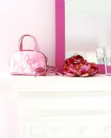 Girls pink accessories on mantelpiece 