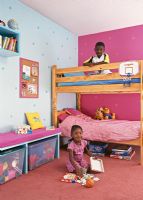 Children in colourful bedroom 
