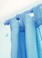 Detail of blue curtains and rail 