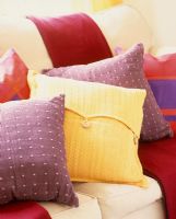 Variety of colourful cushions on sofa 