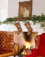 Christmas garland and stockings on mantle piece