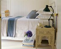 Ornate bedside table in country bedroom 