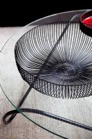 Detail of black wire bowl on coffee table 