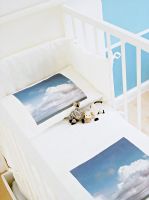 Detail of cloud design bedding in cot