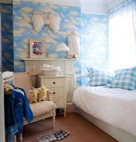 Childrens room with cloud wallpaper 