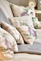 Floral patterned cushions on sofa 