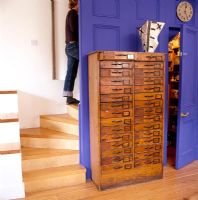 Reclaimed chest of drawers in modern hallway 