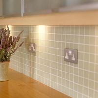 Detail of tiled splash backs in modern kitchen