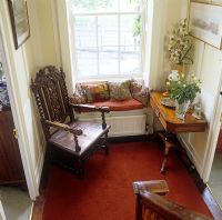 Chair and window seat in classic hallway 