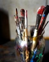 Detail of artists paint brushes in glass 