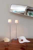 Miniature designer chairs on living room shelf