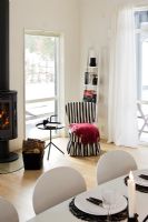 Log burning stove and armchair in dining room 