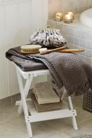 Towels and accessories on bathroom stool 