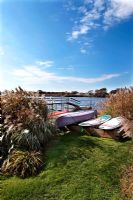 Canoes and surfboards at waters edge 