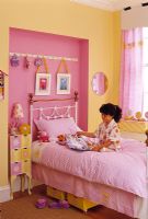 Little girl playing in modern bedroom 