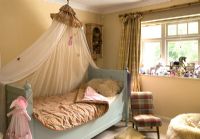 Day bed with canopy in classic childs bedroom 