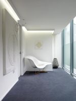 Designer chair at end of contemporary corridor