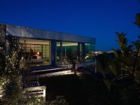 Exterior of glazed contemporary house at night