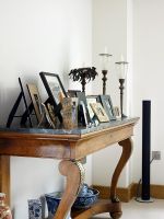 Display of framed photographs on console table