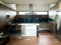 Stainless steel island in modern wooden kitchen