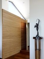 Wooden paneled wall and sculpture in hallway 