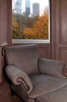 Classic armchair by window with city views 