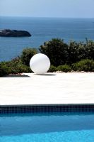 White ball sculpture by swimming pool 