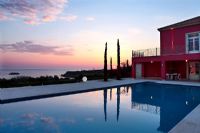 Exterior of villa with pool at sunset