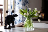 Vase of white tulips and bear candlesticks 