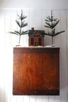 Miniature Christmas scene on wooden cupboard 