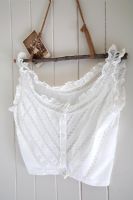 Lace vest hanging on vintage home made hanger 
