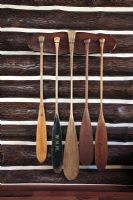 Wooden oars on log cabin wall 