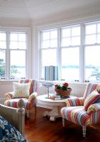 Striped armchairs in country living room 