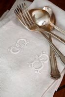 Detail of napkins and silver crockery 