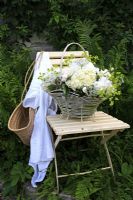 Basket of flowers on vintage chair 