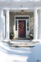 Classic front door and snow covered path