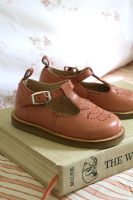 Classic childrens shoes on book 