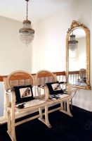 Chairs and mirror in classic hallway 