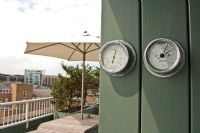 Barometers on garden wall 