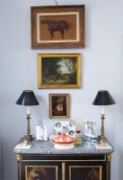 Classic paintings on wall over sideboard