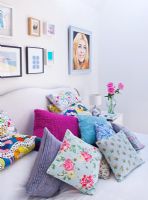 Collection of patterned cushions on bed 