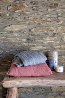 Bathroom accessories on rustic bench 