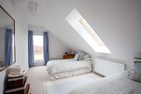 Twin beds in modern attic bedroom 