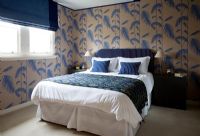 Classic bedroom with patterned wallpaper 