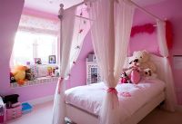 Pink childrens bedroom with four poster bed 