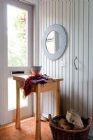 Table and mirror in country hallway 