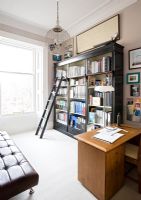 Ladder by bookcase in classic study 